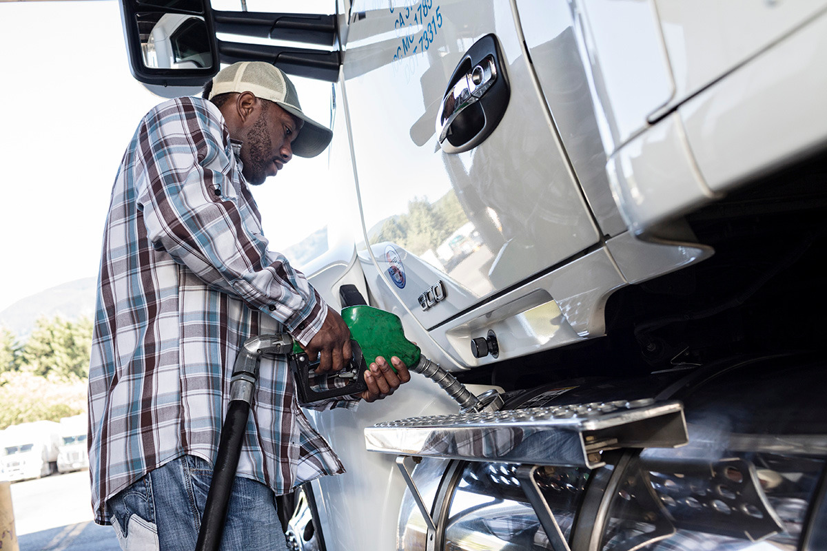 truck-driver-putting-diesel-fuel REK Driver Refueling